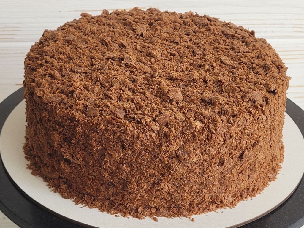 Napoleon chocolate–cherry cake in Lisbon to order — whole cake in dark crumbs, homemade finish.